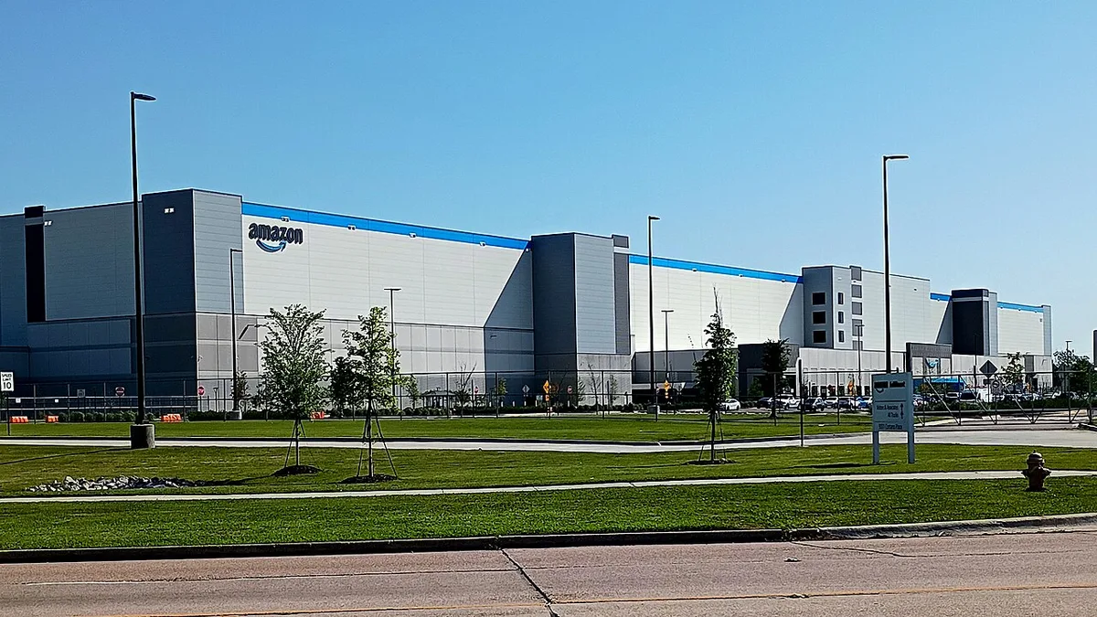 Exterior of a large Amazon fulfillment warehouse building.