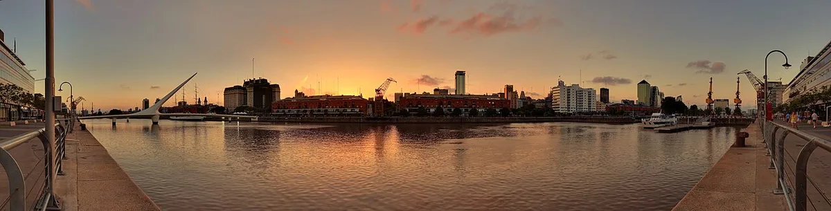 Panoramic view of high-rise buildings along the Puerto Madero waterfront in Buenos Aires at sunset.