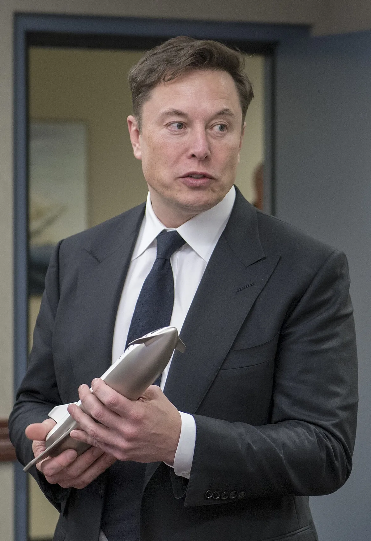 Elon Musk, CEO of SpaceX, speaks to a group of people.