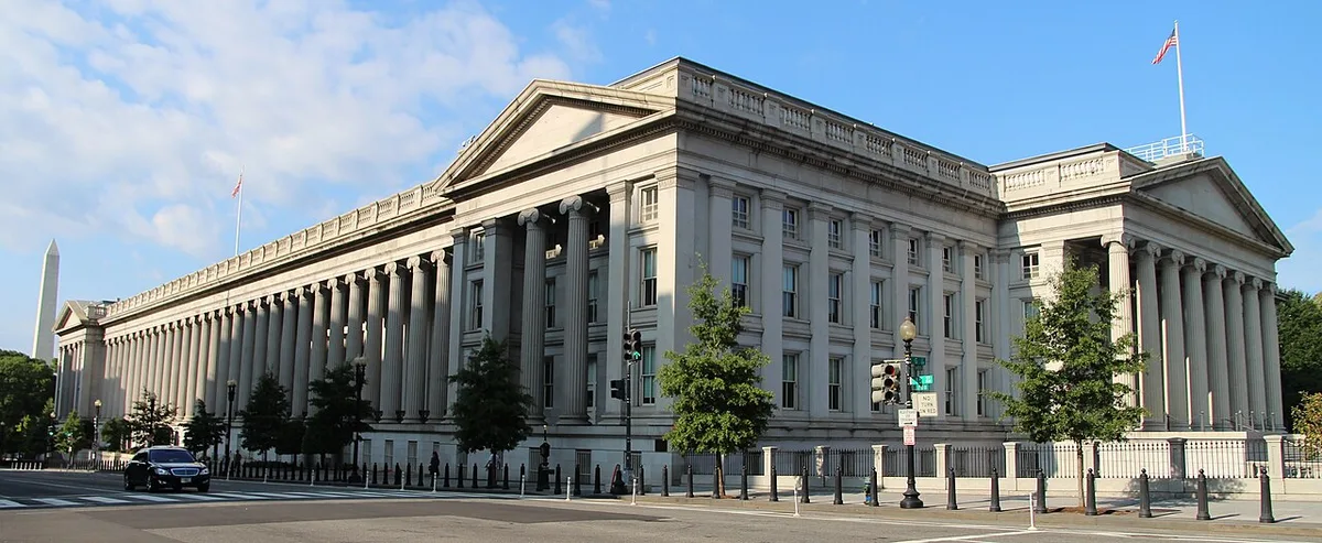 Exterior view of the neoclassical United States Treasury Building with tall columns.
