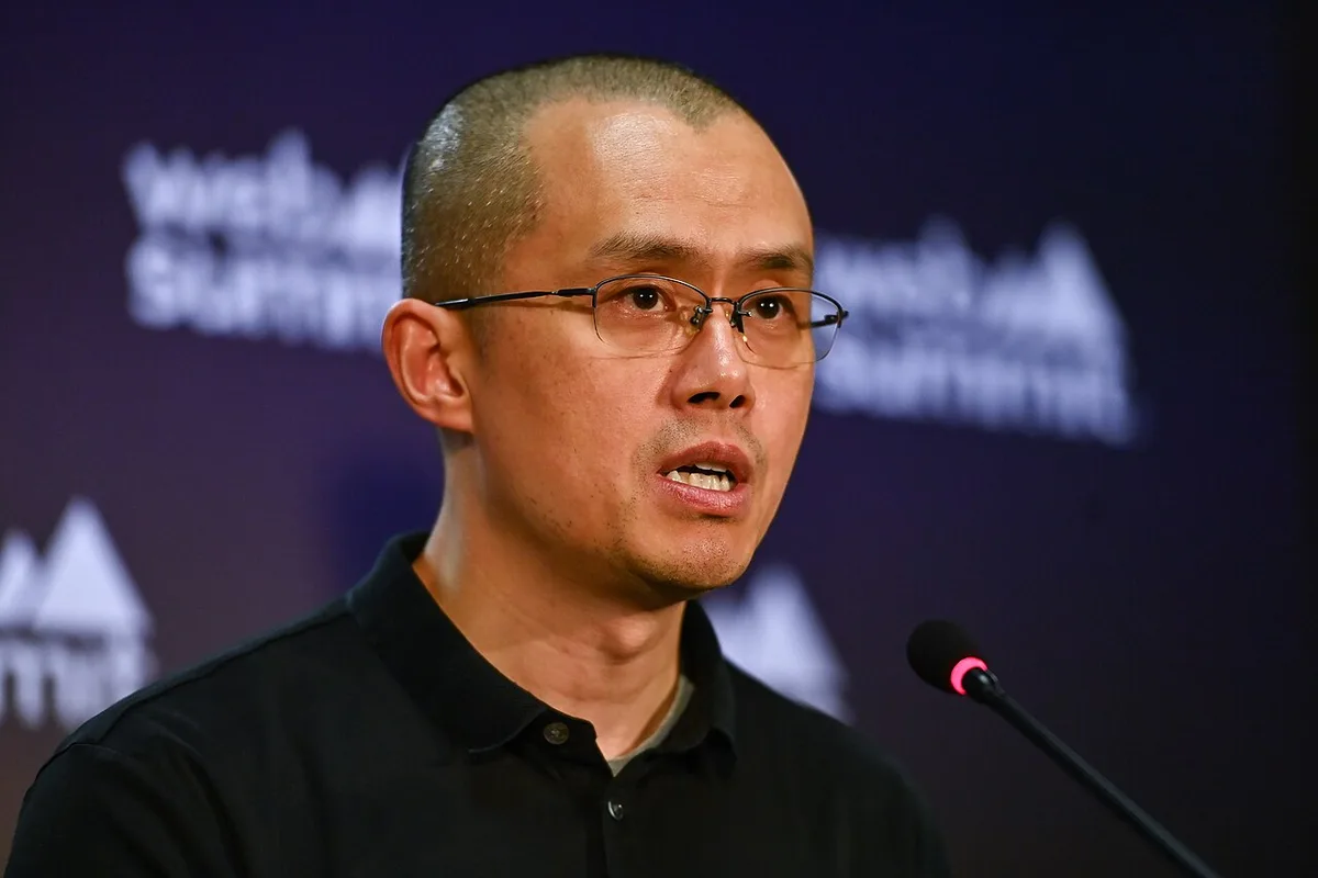 Changpeng Zhao seated and speaking at a Web Summit press conference.